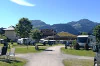 Comfort Camp Grän  -  Wohnwagen- und Zeltstellplatz auf grüner Wiese mit Blick auf die Berge