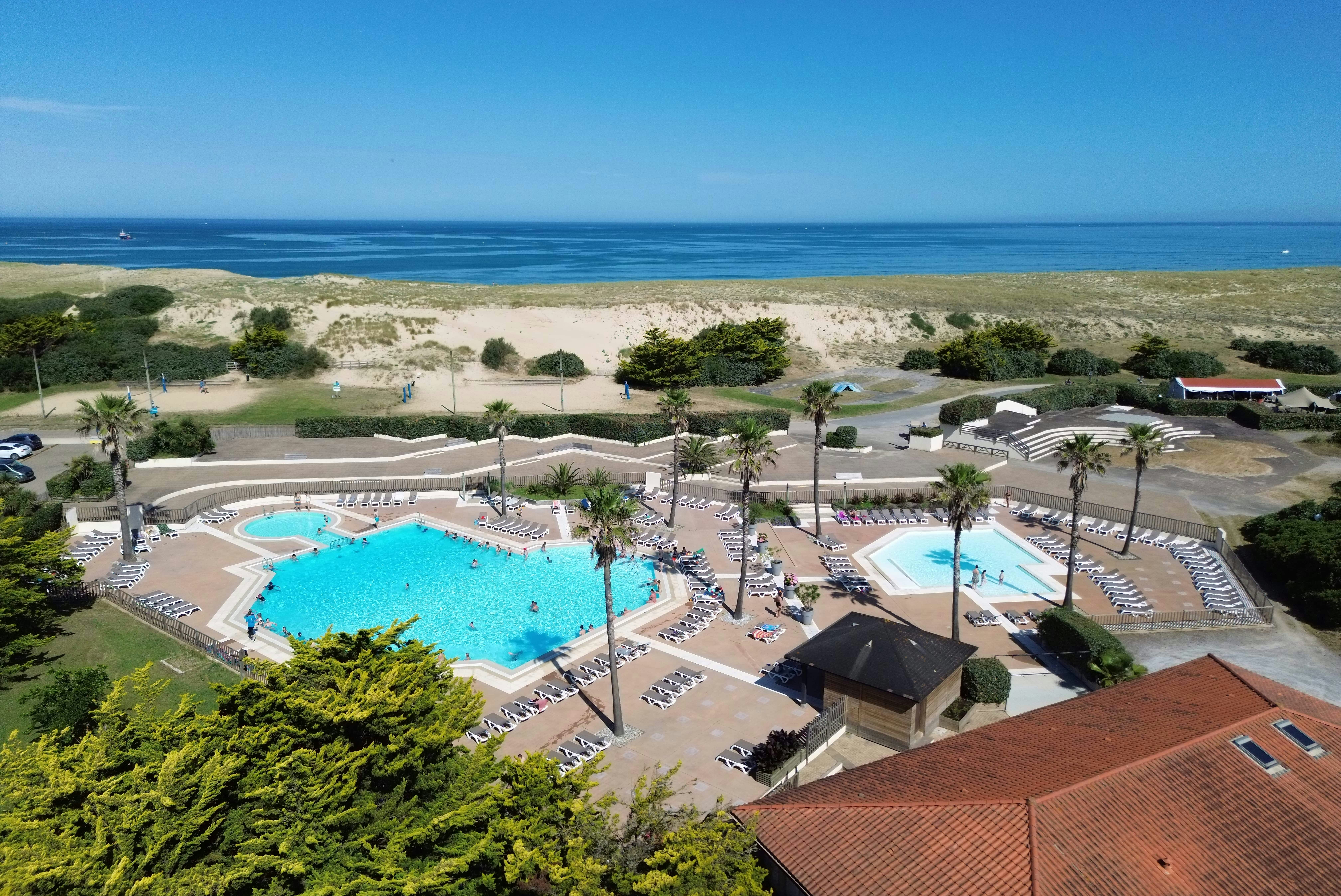 Camping Domaine de Fierbois  - Luftaufnahme des Campingplatzes mit Freibad und Meer im Hintergrund