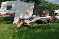 Camping  Le Pontet - Gäste beim Entspannen auf einem schattigen Stellplatz