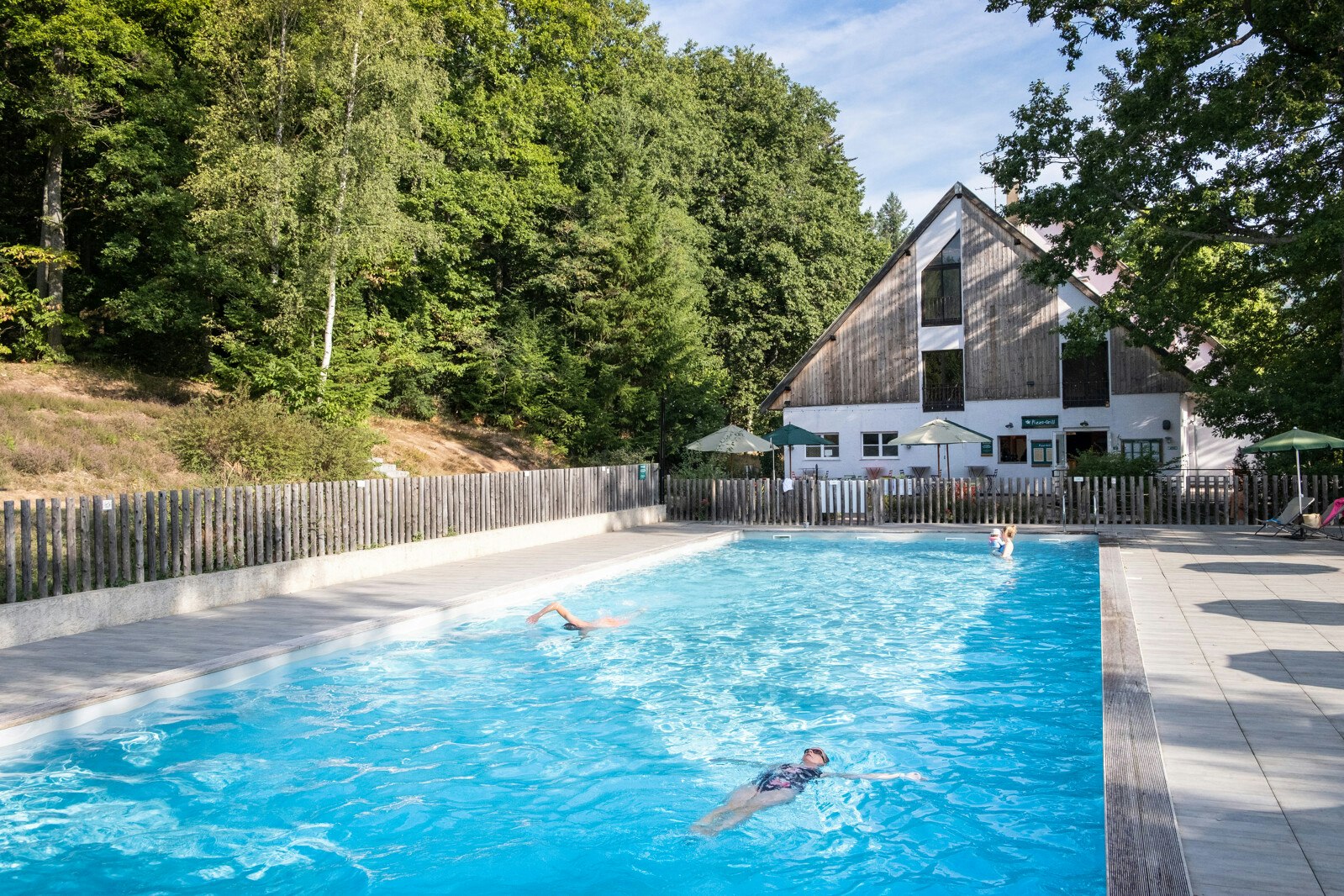 Huttopia Wattwiller  - Pool im Freien mit Liegestühlen und Sonnenschirmen