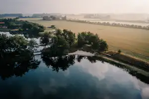 Hygge Lake - Blick auf den See mit Feldern im Hintergrund