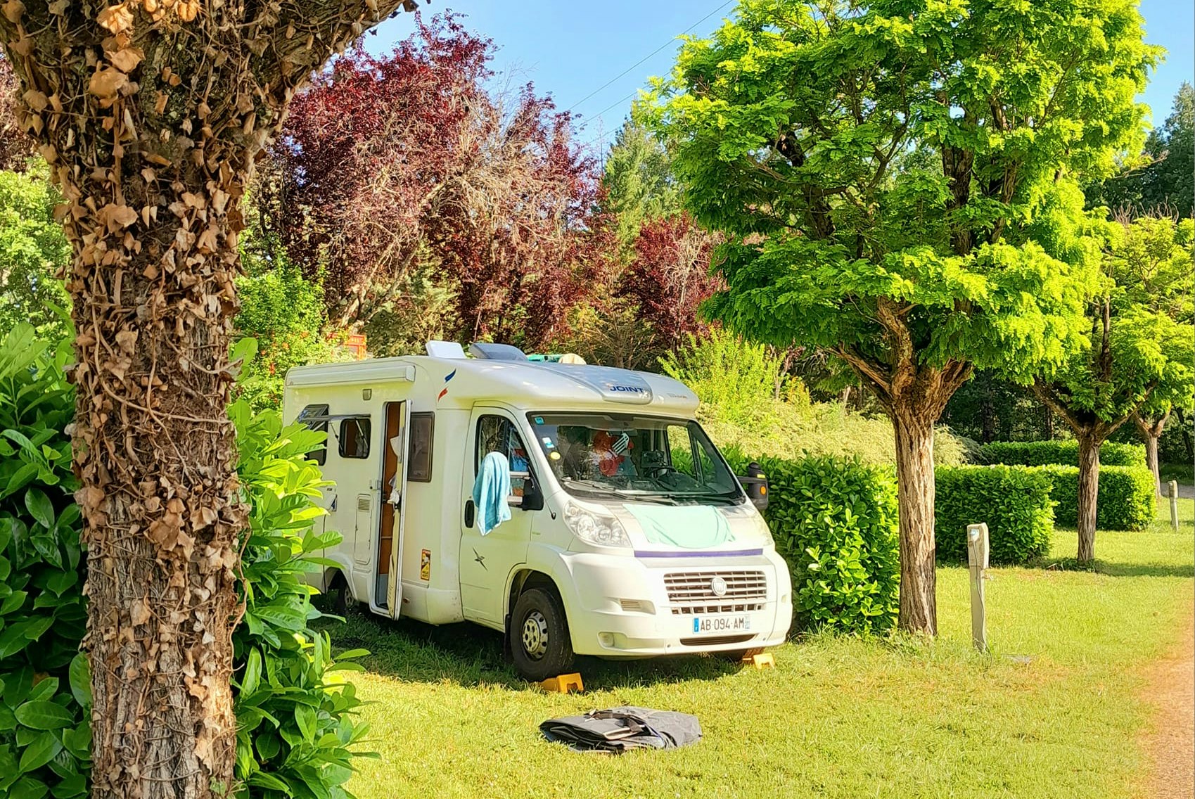 Les Auzerals Camping du Lac - Standplätze zwischen den Bäumen auf dem Campingplatz