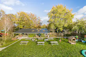Buitengoed Holthees Minicamping Buitenboel Bij ons4 - Terrasse mit Picknickbänken und Kinderspielgeräten