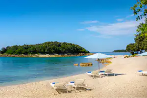 Naturist Camping Istra - Strand vom Campingplatz mit Sonnenschirmen und Liegestühlen am Adriatischen Meer