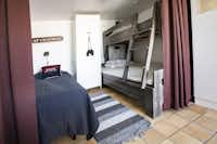 Ramsvik Stugby & Camping - Schlafbereich mit drei Betten in einem Mobilheim