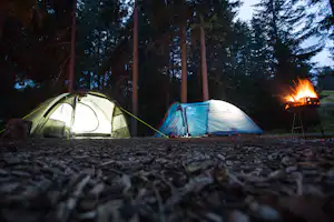 Camping Gravas - Blick auf Zeltplätze und einen Grill bei Abend