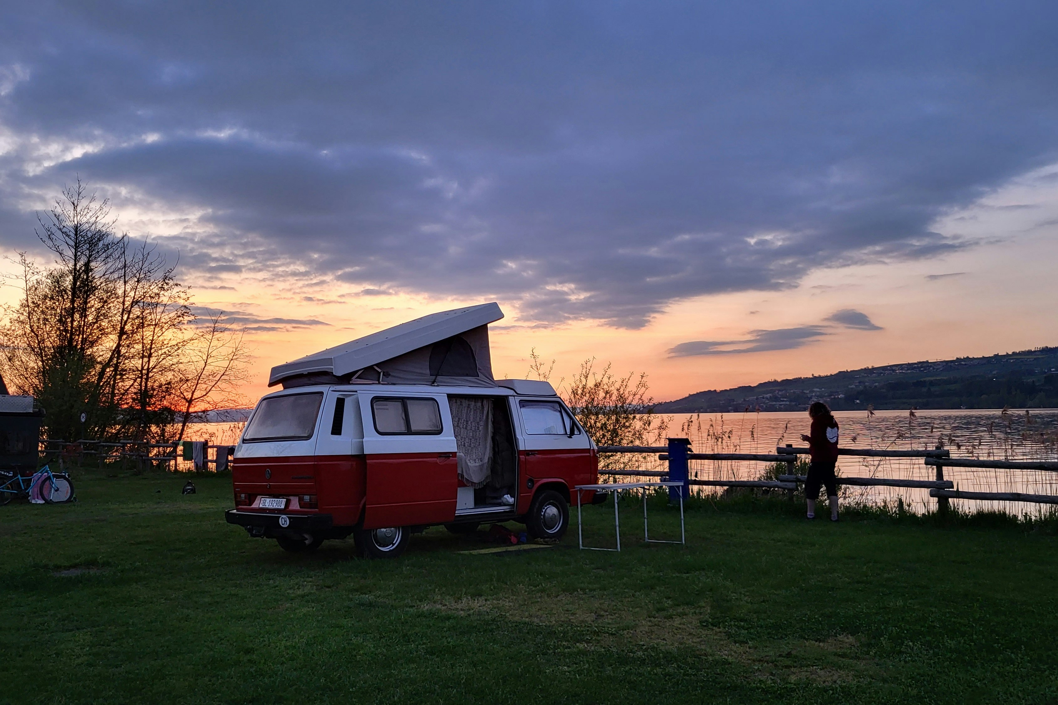 TCS-Camping Sempach - Blick auf einen Standplatz am Ufer des Sees bei Sonnenuntergang