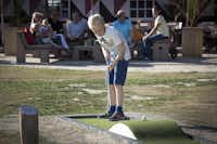Vakantiepark Beekse Bergen  - Minigolf spielendes Kind auf dem Campingplatz