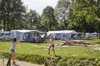 Vakantiepark Leukermeer  -  Volleyball spielende Kinder auf dem Wohnwagenstellplatz und Wohnmobilstellplatz vom Campingplatz im Grünen