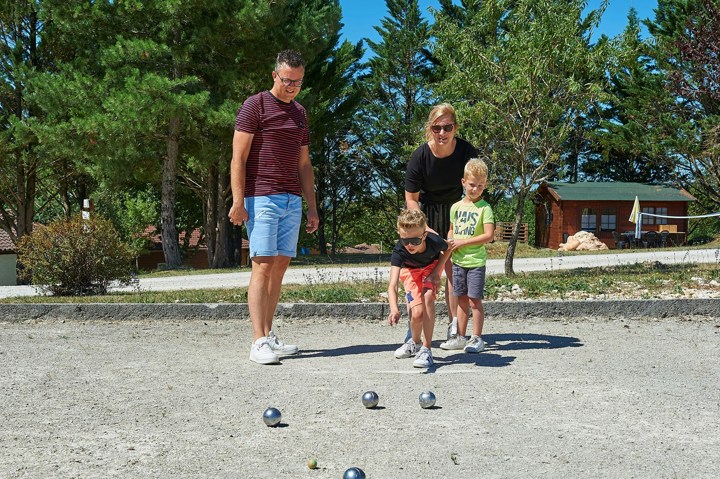 Village des Cigales - Familie spielt Pétanque auf dem Campingplatz