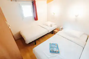 Wellness Sport Camping Ax-Les-Thermes- Schlafzimmer mit zwei Einzelbetten in einem Mobilheim