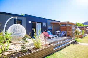 Yelloh! Village Sant Miquel - Blick auf Mobilheim mit Veranda im Sonnenlicht auf dem Campingplatz