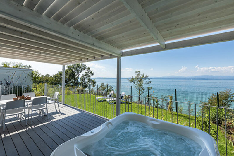 Terrasse eines Mobilhomes des Campingplatzes mit Whirpool und Blick auf das Meer