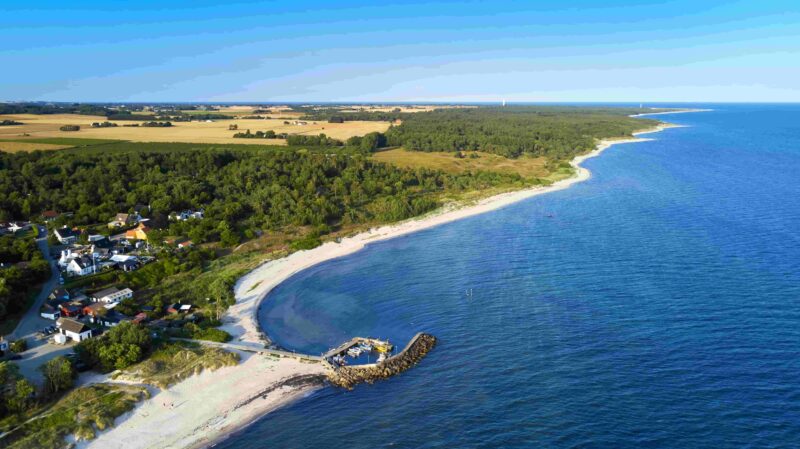 Strand und Küste im Süden der dänischen Ostsee-Insel Bornholm mit kleinem Hafen in der Nähe von Østersømarken im Sommer mit Blick in Richtung Dueodde